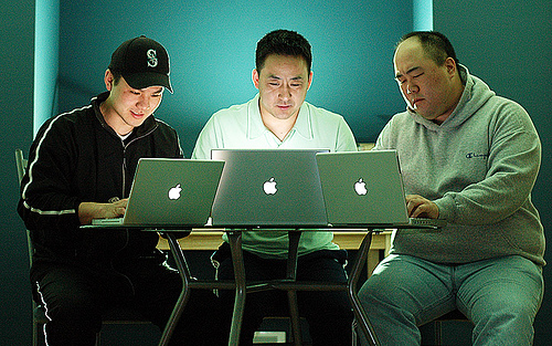 3 men working on laptops